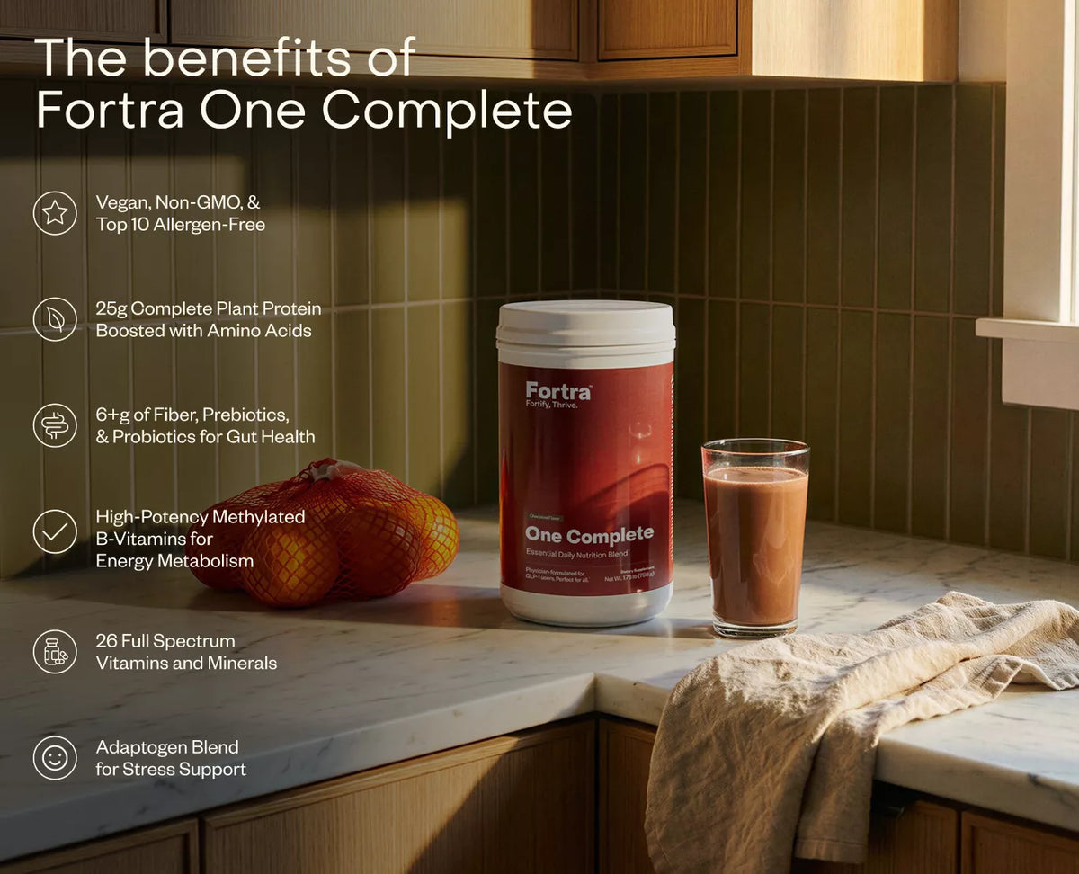 Fortra One Complete supplement container on a kitchen counter with a glass of its product.